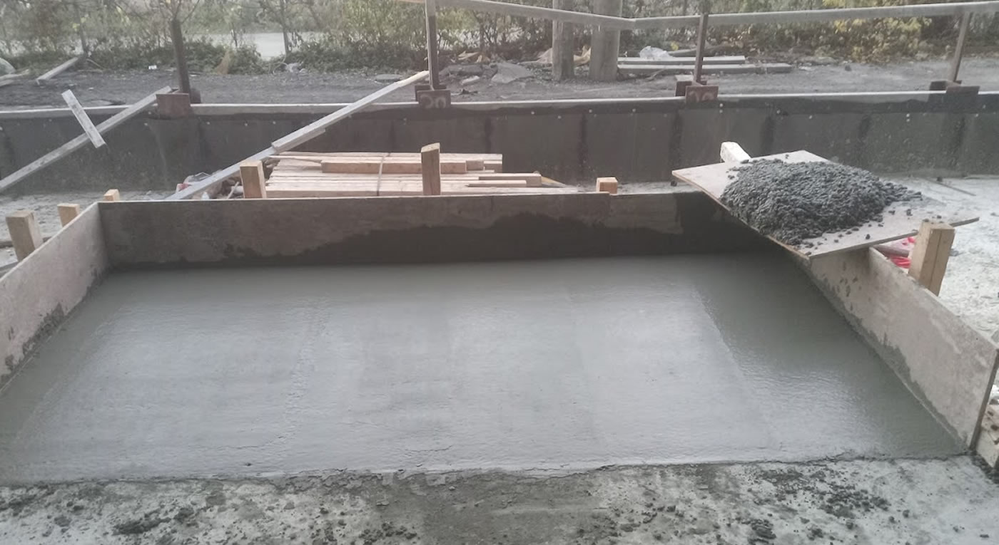 Freshly poured concrete slab in its forms