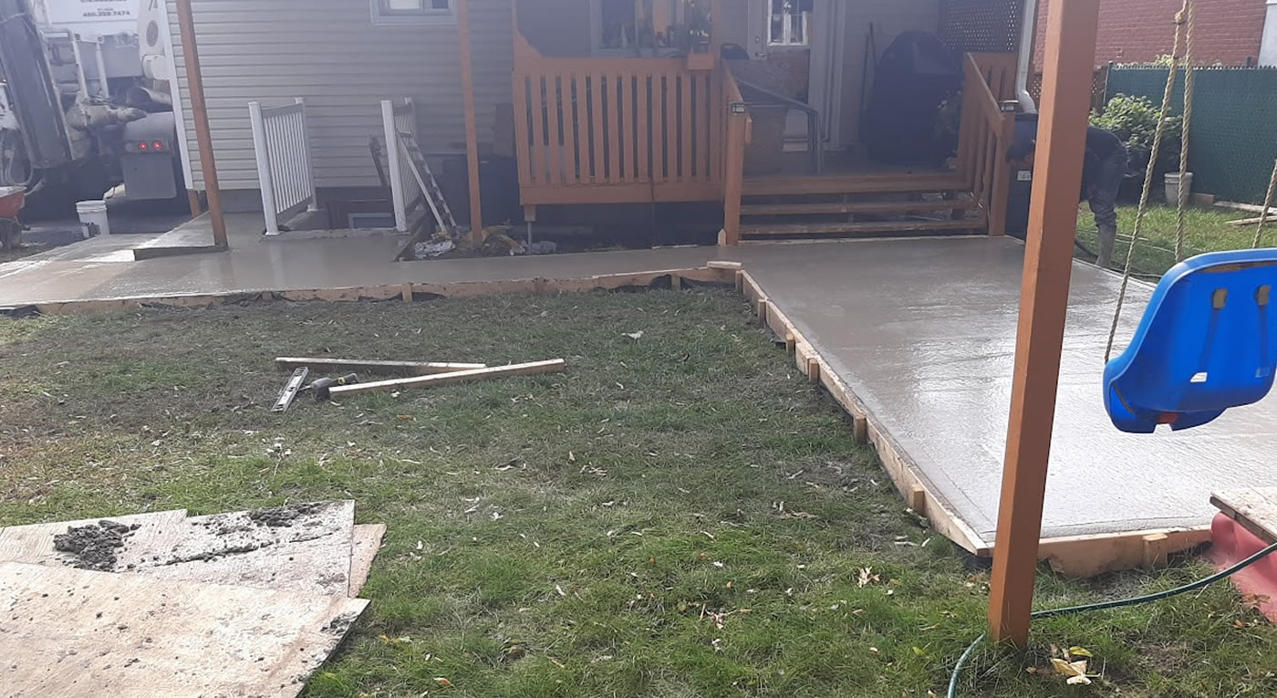 Poured concrete patio in a backyard